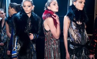 Six female models wearing multicoloured patterned pieces from Roberto Cavalli's collection. Some pieces feature fur and some are sleeveless