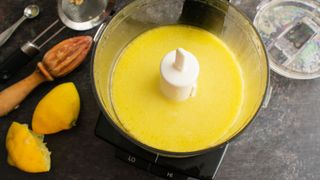 A food processor making lemon dressing