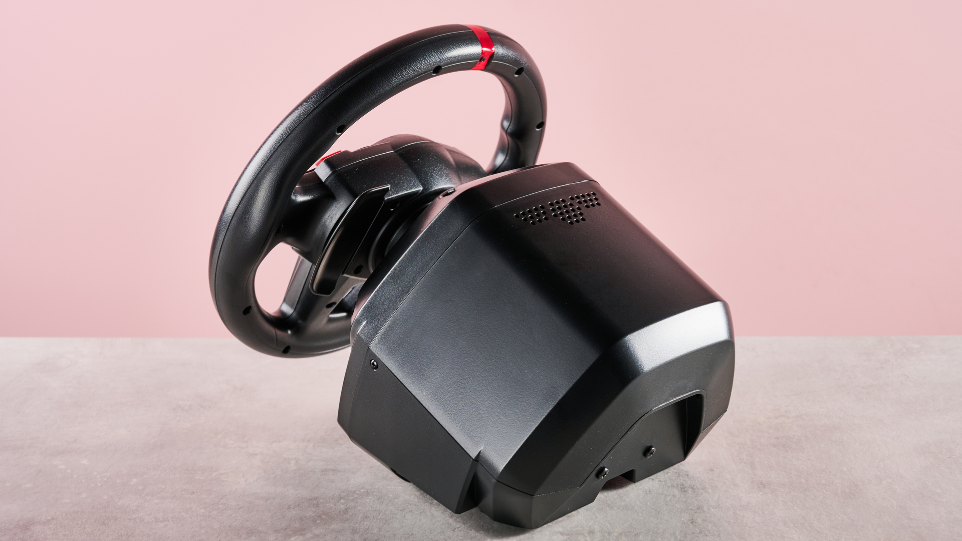 Back of Thrustmaster T128, on desk with pink background