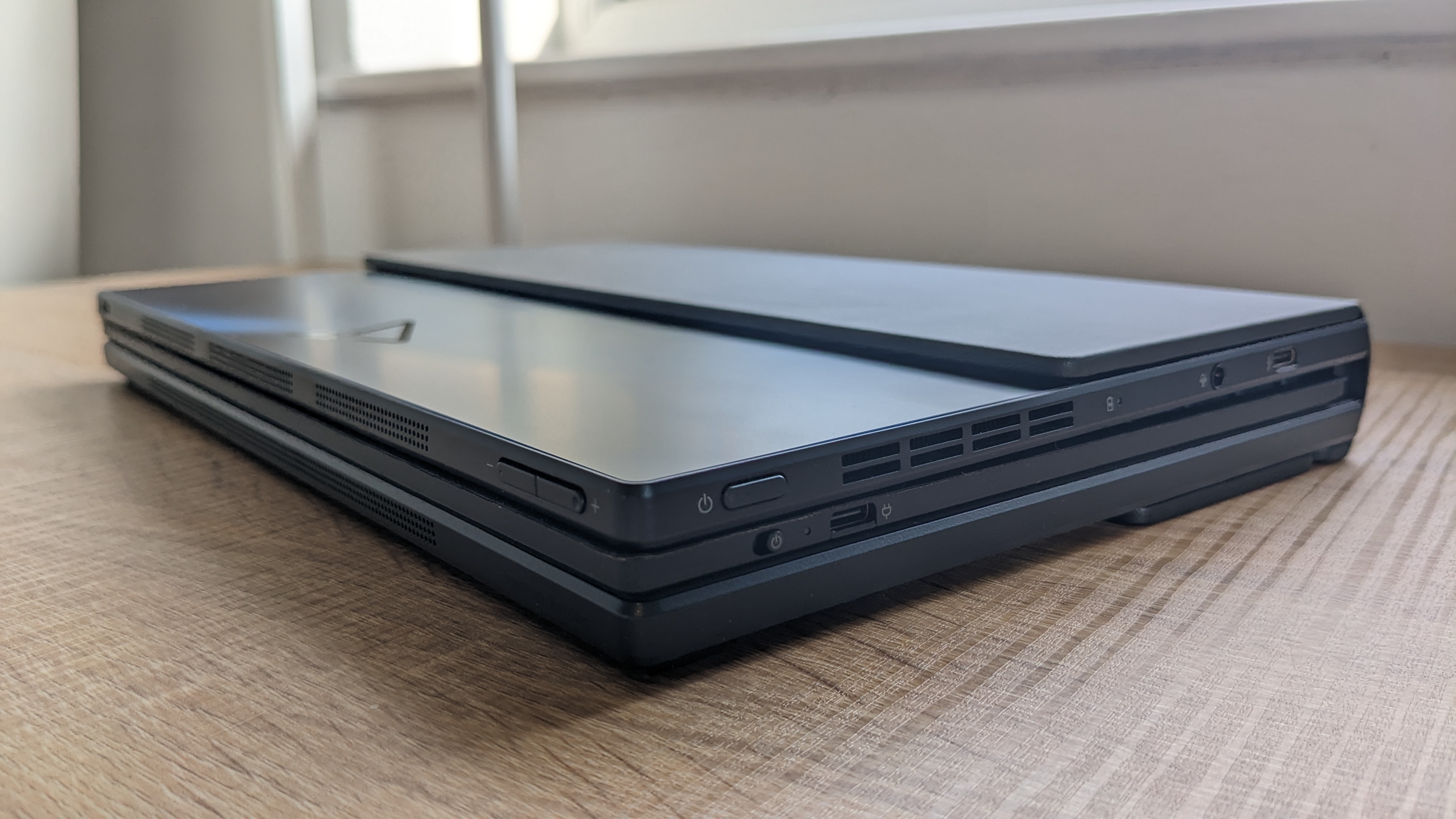 The Asus Zenbook 17 Fold OLED pictured on a wooden desk.