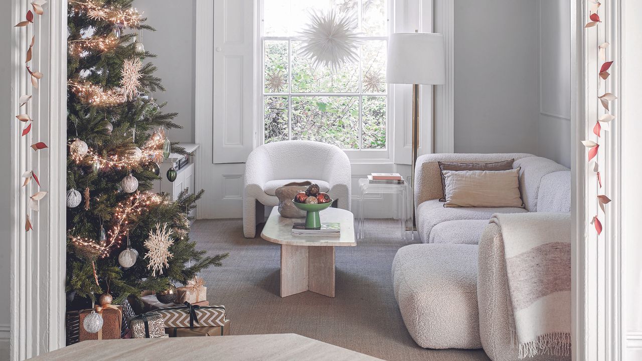 White and beige living room with Christmas tree.