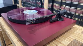 Pro-Ject Debut Evo 2 turntable slight angle with coloured vinyl on platter