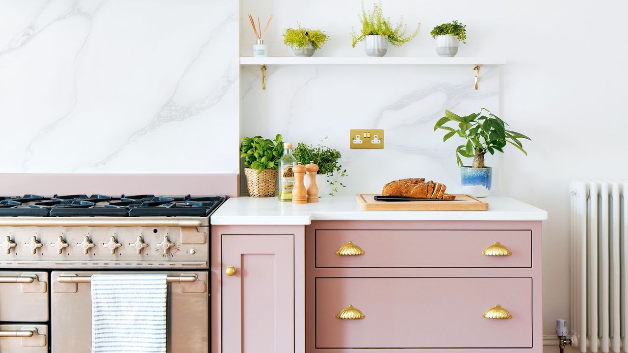 Kitchen with white marble splashback and pink painted cabinetry