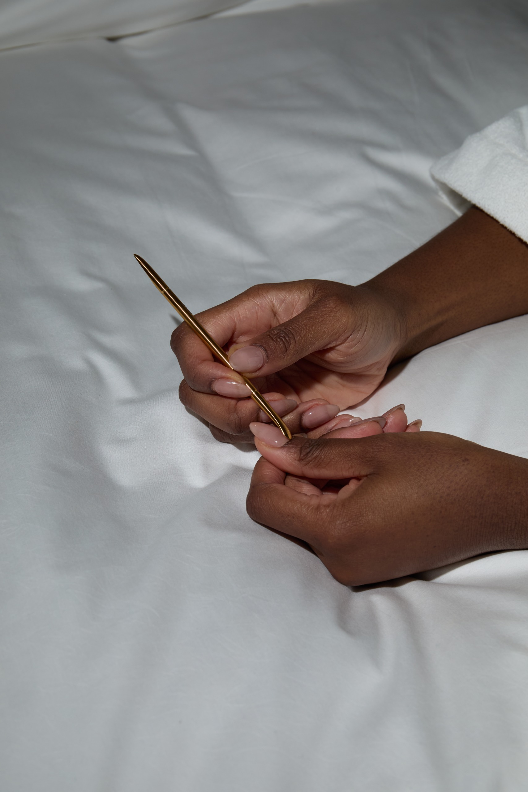A close-up picture of the Navy Professional Doris Curved Manicure Pusher in action