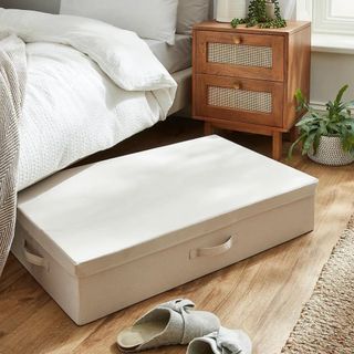 Cream under the bed storage box in a bedroom