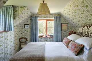 vintage attic bedroom with wallpapered ceiling by Vanrenen GW Designs