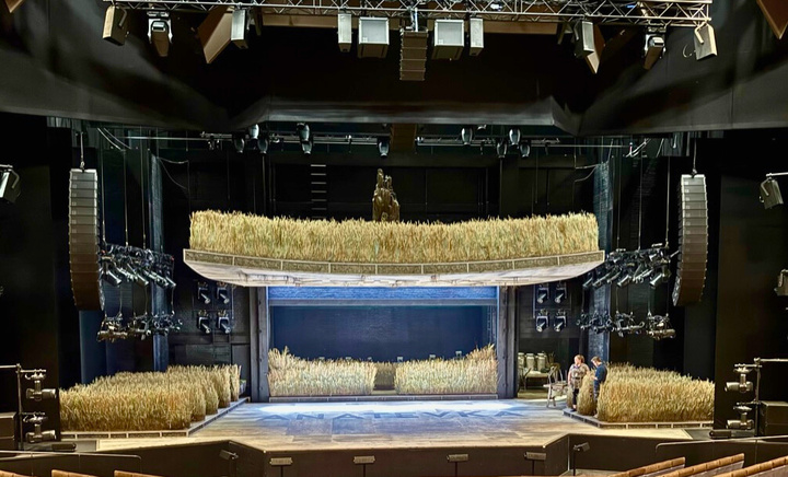 A scene from the musical &#039;Fiddler on the Roof&#039; with a man leaping in a split.