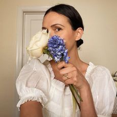 Yoga with Adriene: the yoga instructor smelling flowers 