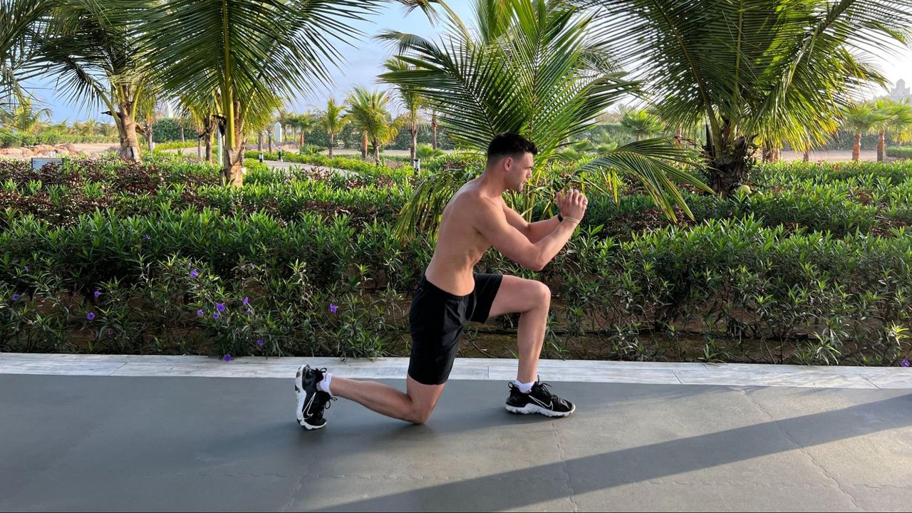 Sam Shaw holding a reverse lunge
