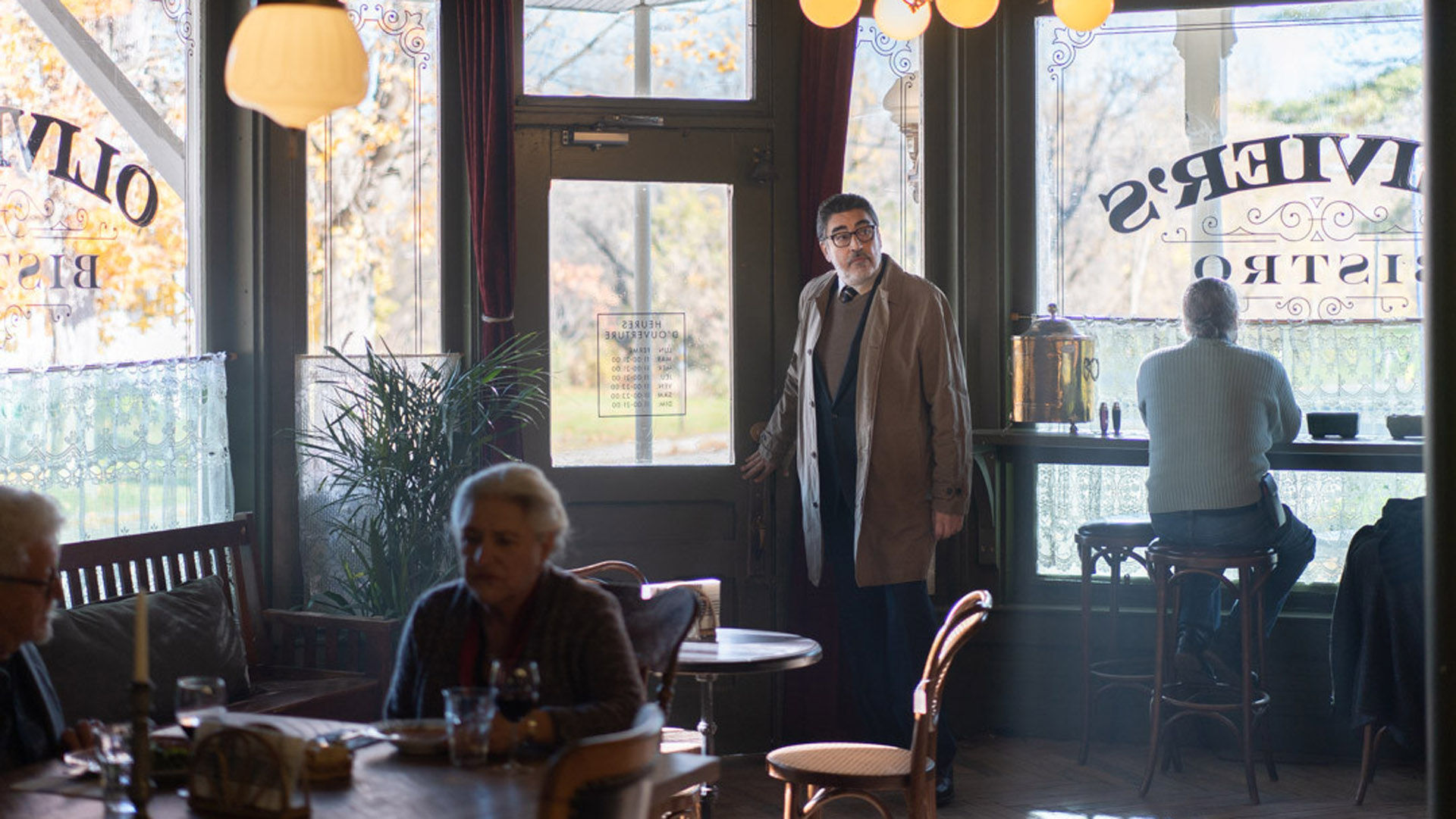 Inspector Armand Gamache enters a cafe in Prime Video's Three Pines TV series