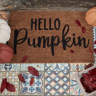 Hello Pumpkin Halloween doormat on patterned tiles