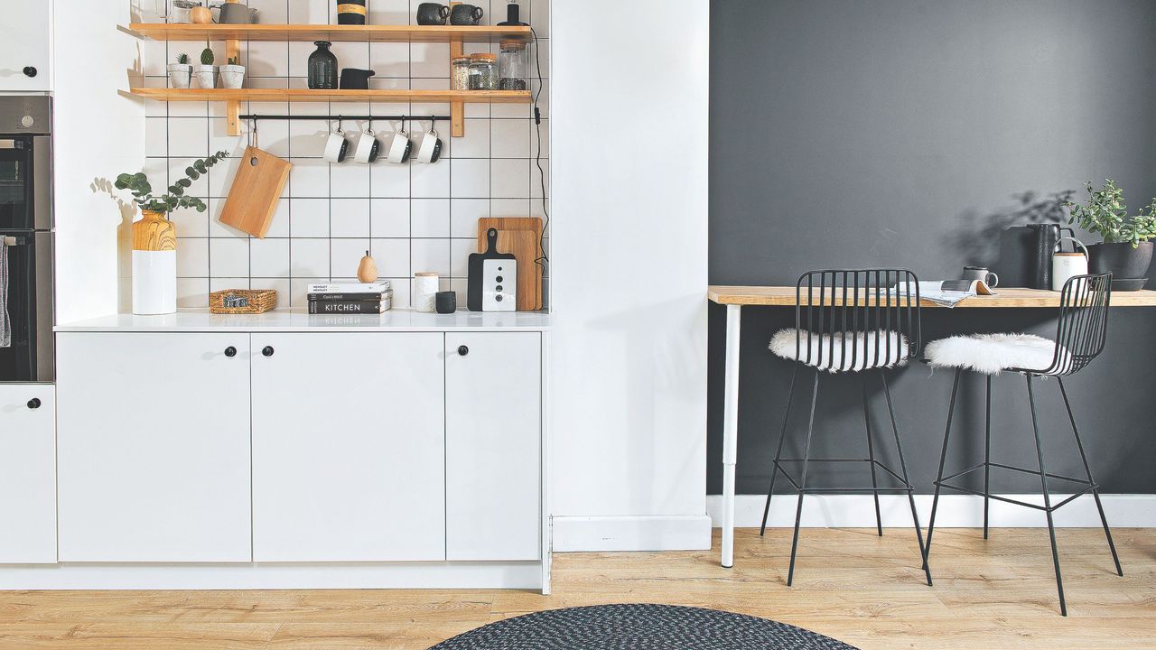 White kitchen and breakfast nook with wooden-effect vinyl flooring