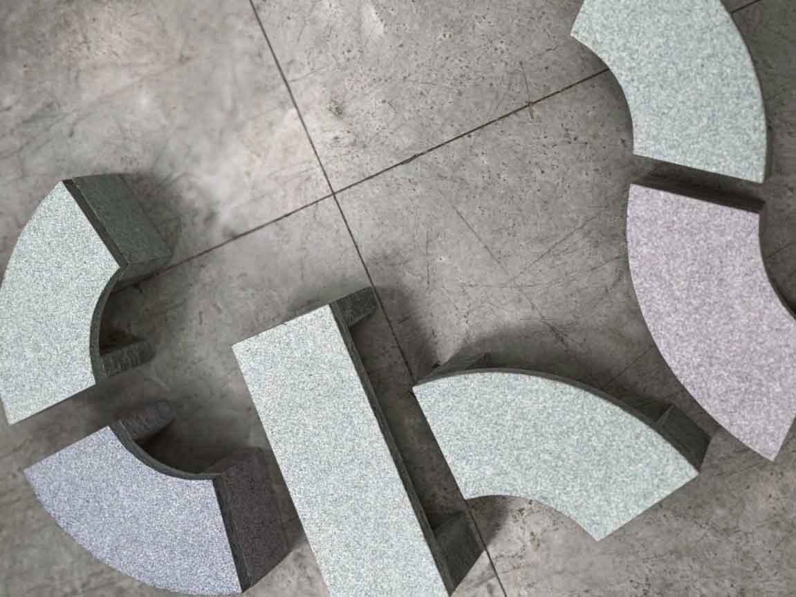 Benches photographed from above, arranged into a shape that is reminiscent of the GBP symbol