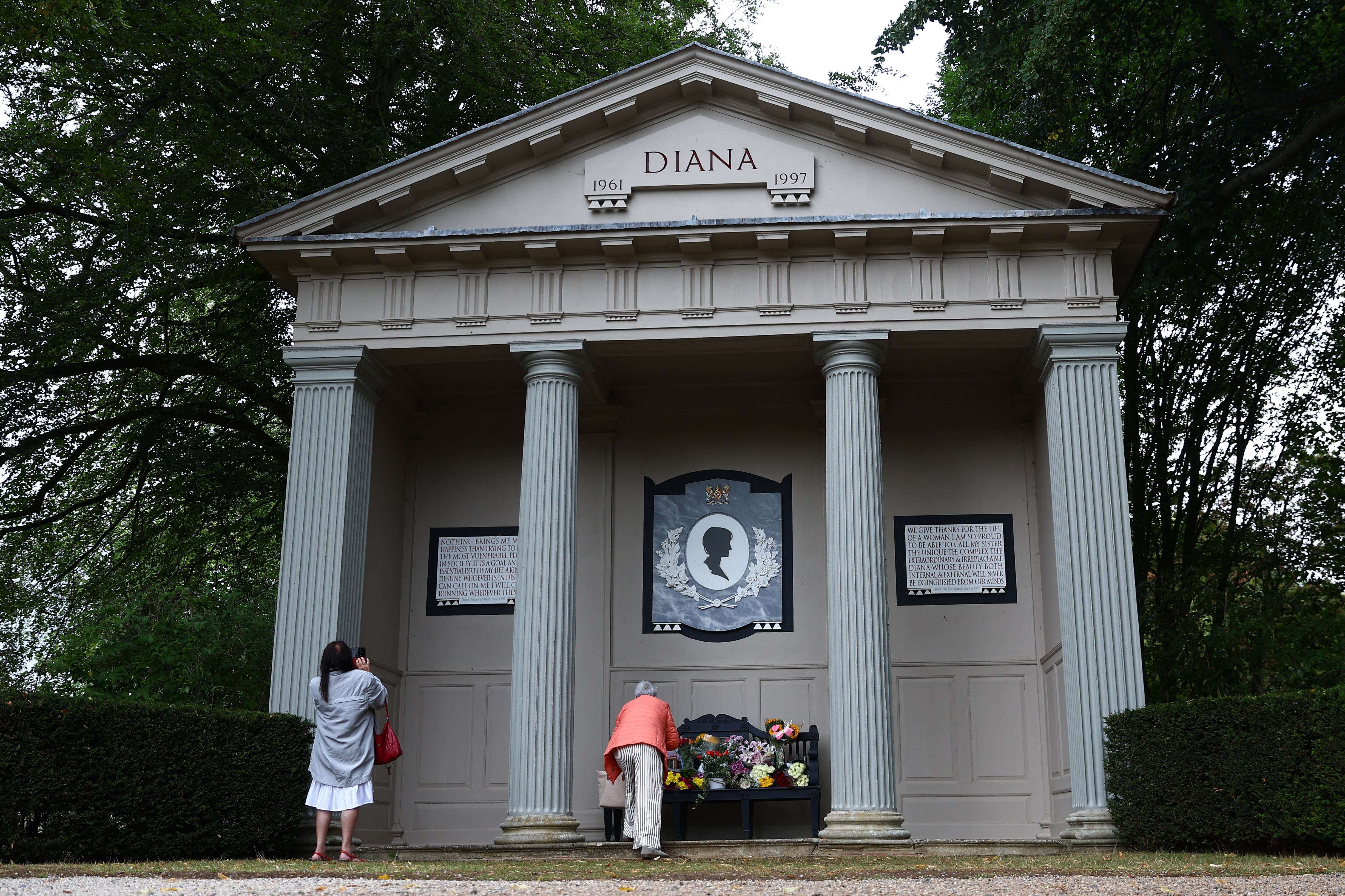 Visitors leaving flowers at a temple dedicated to Princess Diana