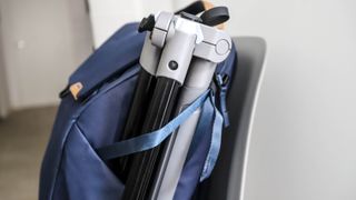 A tripod strapped into a side pocket of the Peak Design Everyday Backpack 20L V2