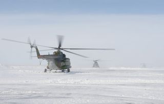 Soyuz spacecraft recovery helicopters take center stage as recovery teams prepare to retrieve the two Expedition 22 astronauts after landing in Kazakhstan.