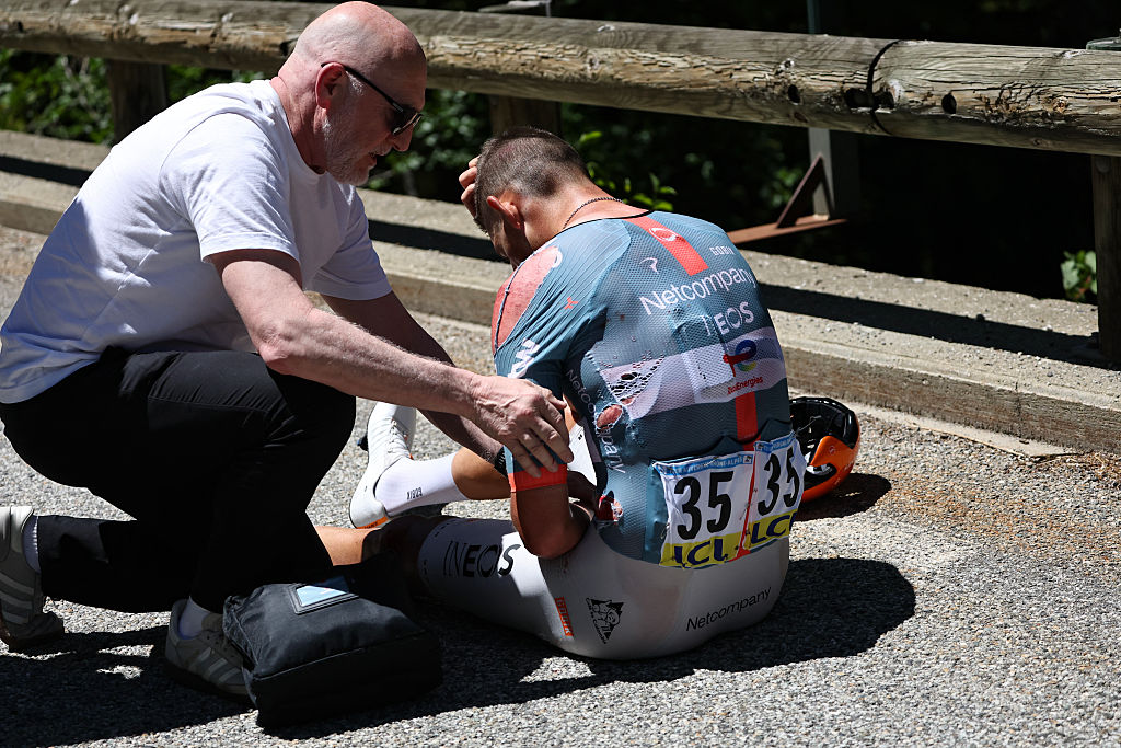 Netcompany Ineos Cycling Team's British rider Joshua Tarling receives attention after suffering a crash during the 6th stage of the Tour Auvergne-Rhone-Alpes cycling race (formerly known as the Criterium du Dauphine), 182,3km between Saint-Vulbas and Crest-Voland in the French Alps on June 12, 2026. (Photo by Anne-Christine POUJOULAT / AFP)