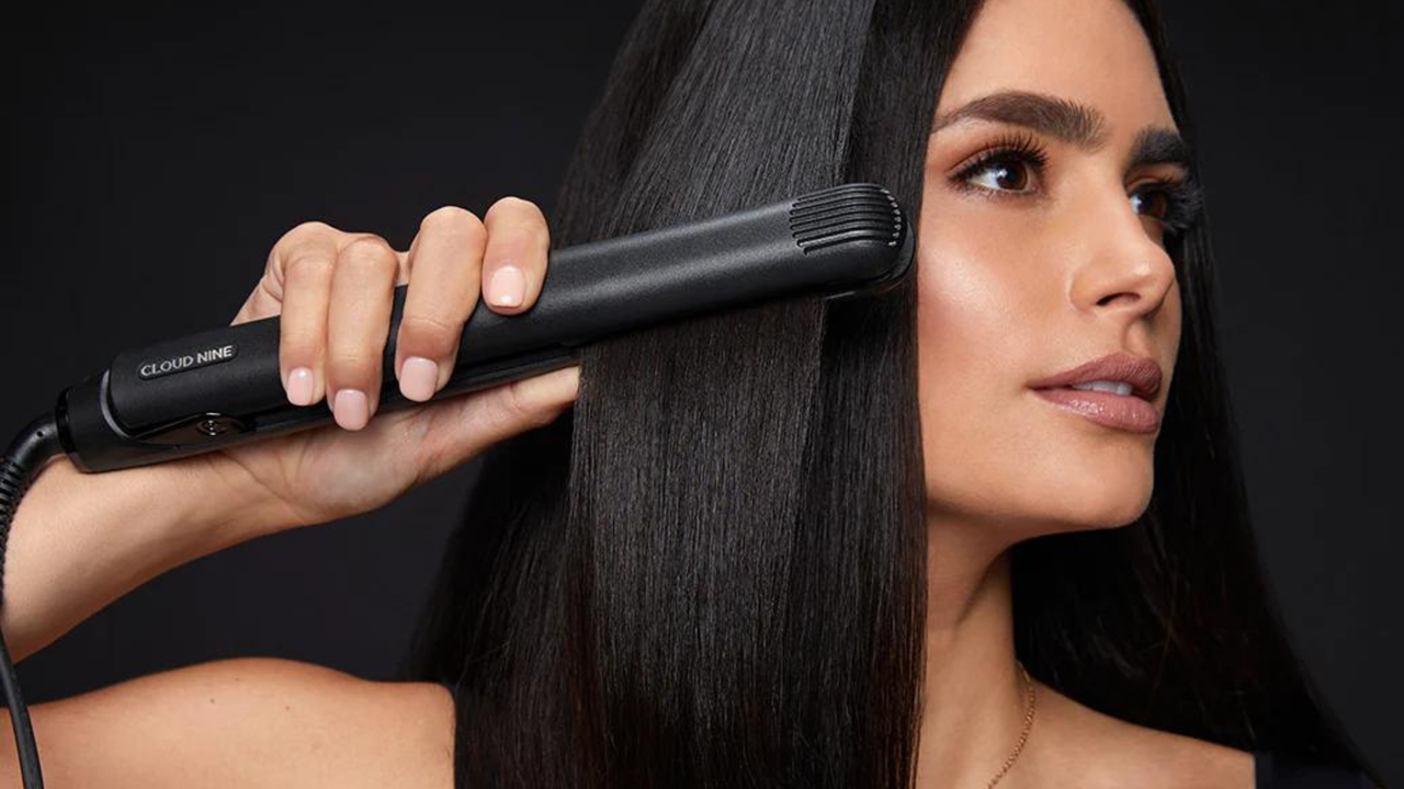 woman straightening hair