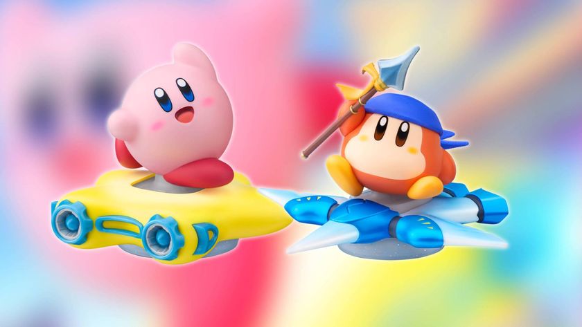 Close up of the Kirby and Bandana Waddle Dee amiibo figures from Nintendo, with the Kirby Air Riders key art blurred in the background.