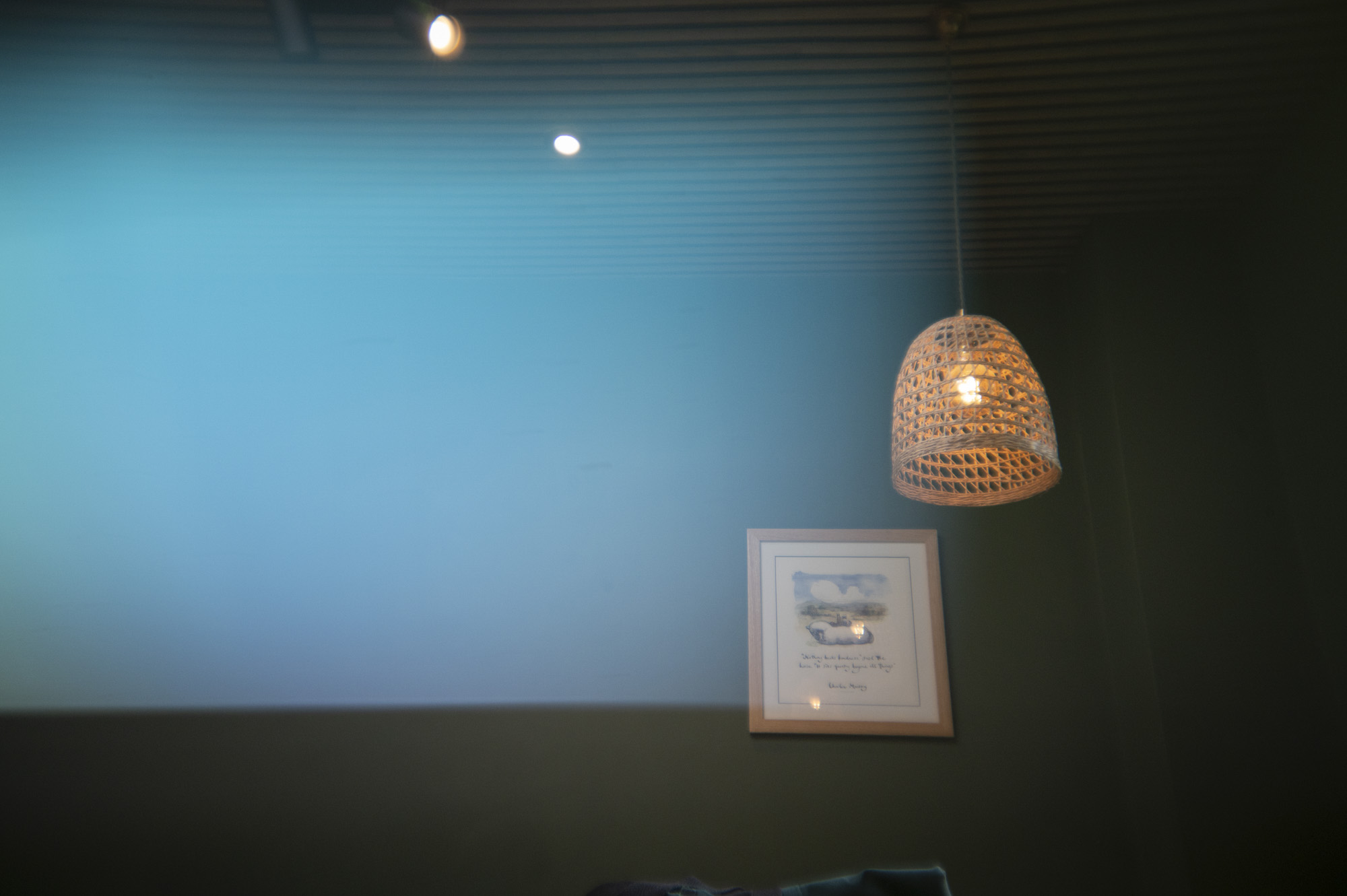 A lamp shade inside a cafe, with light leak effect