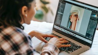 Woman using photo software on laptop