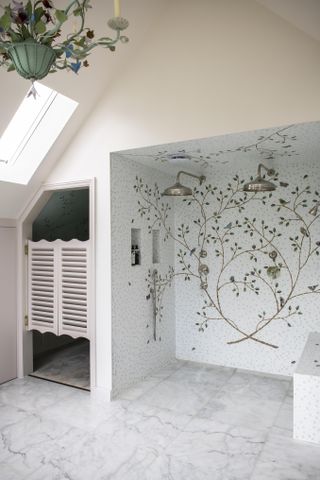 walk in shower with floral mosaic display