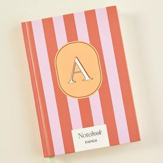 A red and pink striped journal with a large monogram A on the front. 