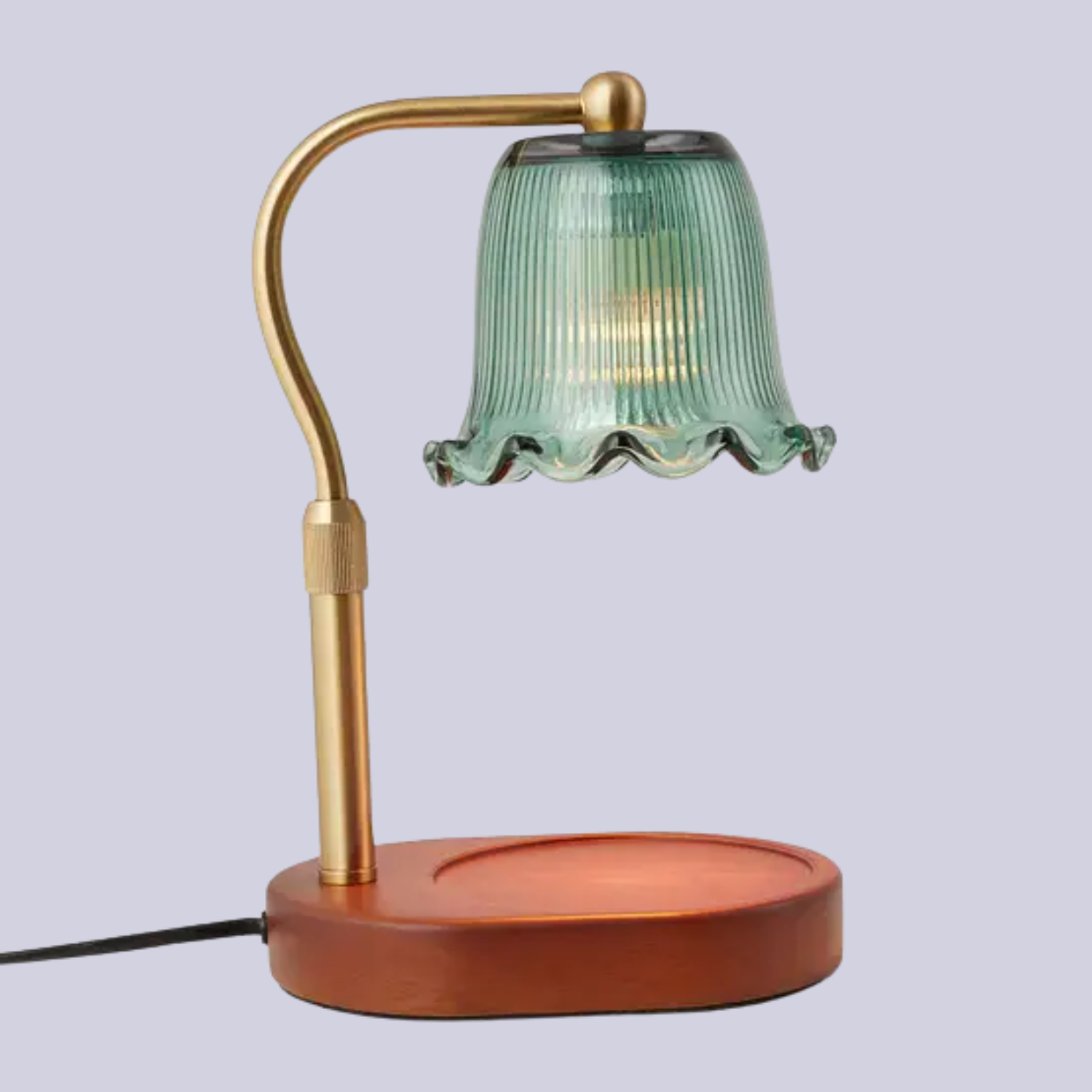 A candle warmer with a wood base, a gold stem, and a green glass shade