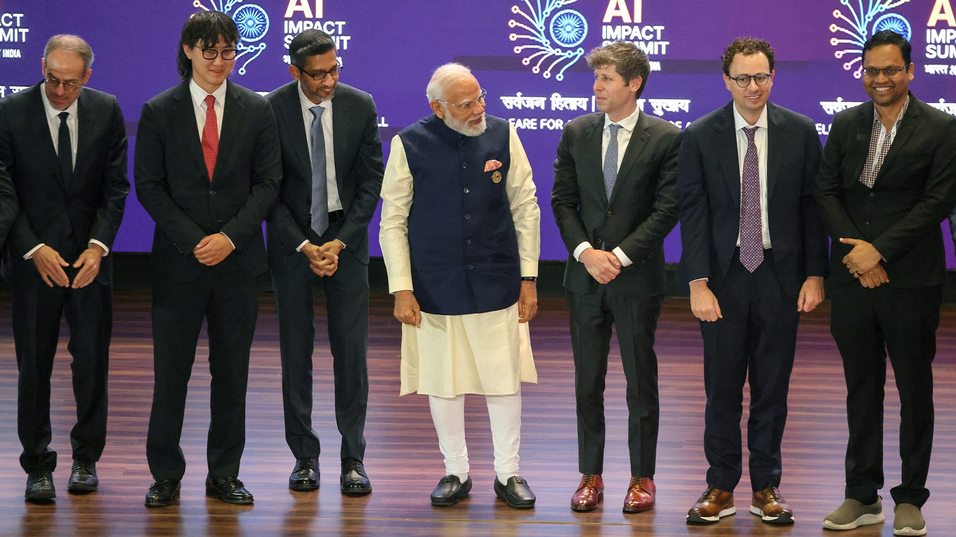 OpenAI CEO Sam Altman pictured with India's Prime Minister Narendra Modi and industry executives including Anthropic CEO Dario Amodei at the AI Impact Summit in New Delhi, India.
