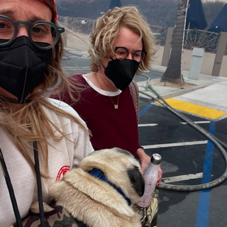 Photo of Mel Sobolewski (Left) and a woman and her dog who she helped rescue.