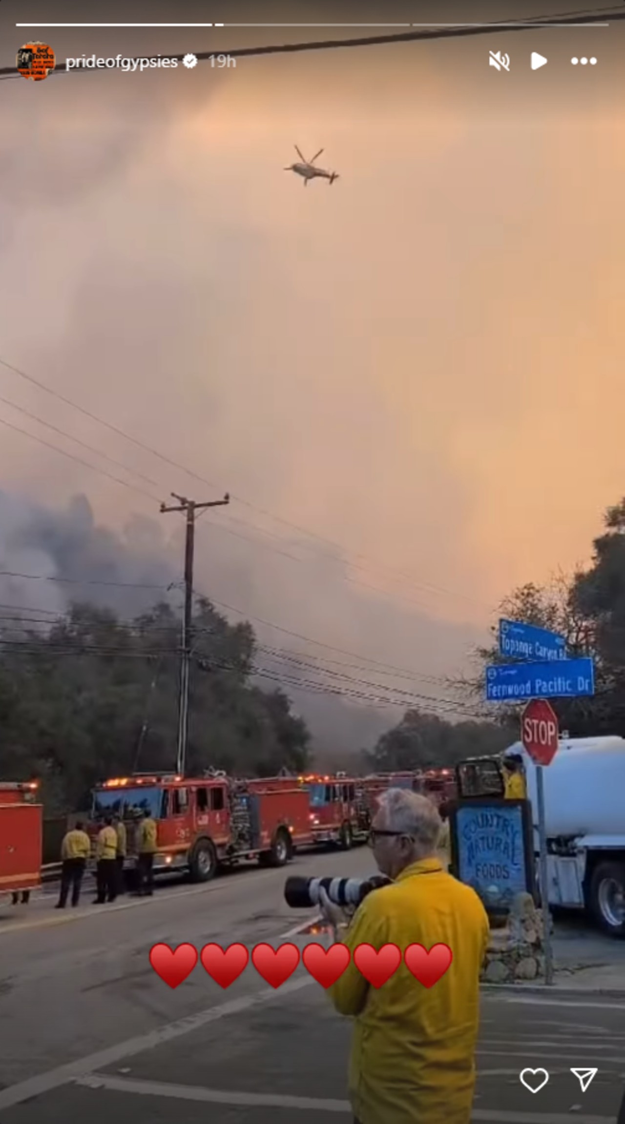 Jason Momoa posted a video of the fire trucks holding the line as a helicopter flew over the fire and dumped water. His caption was six red hearts.