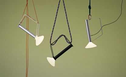 Portable lamp by Muuto in anodized aluminium on a green background