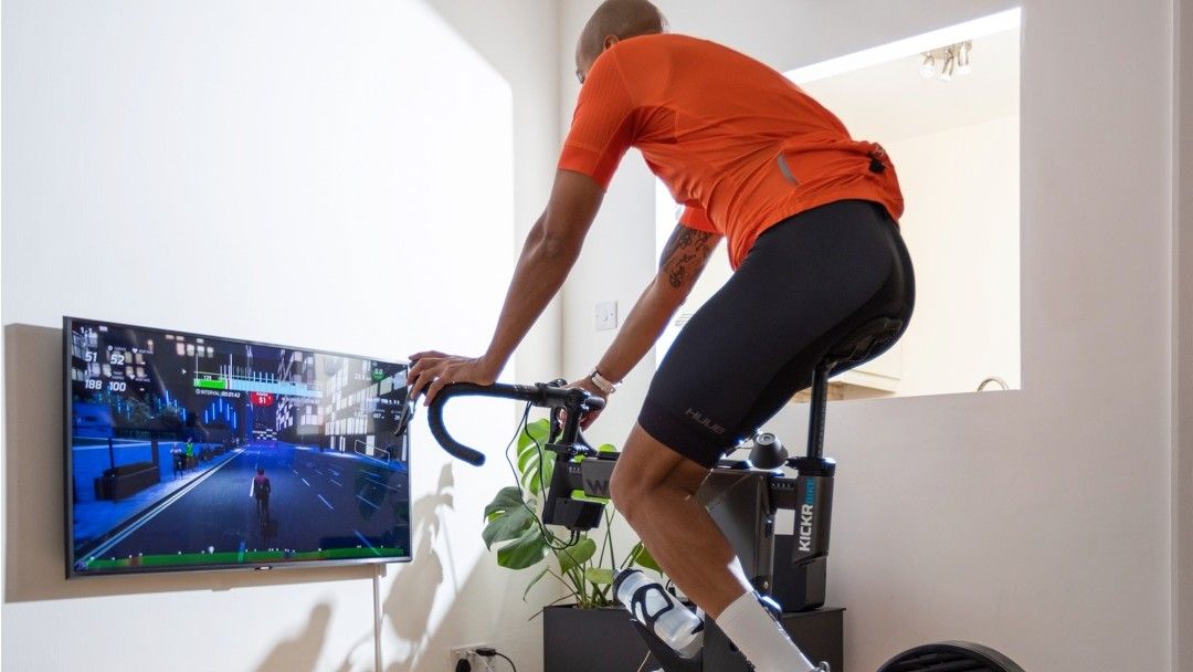 Man riding turbo trainer using Wahoo RGT