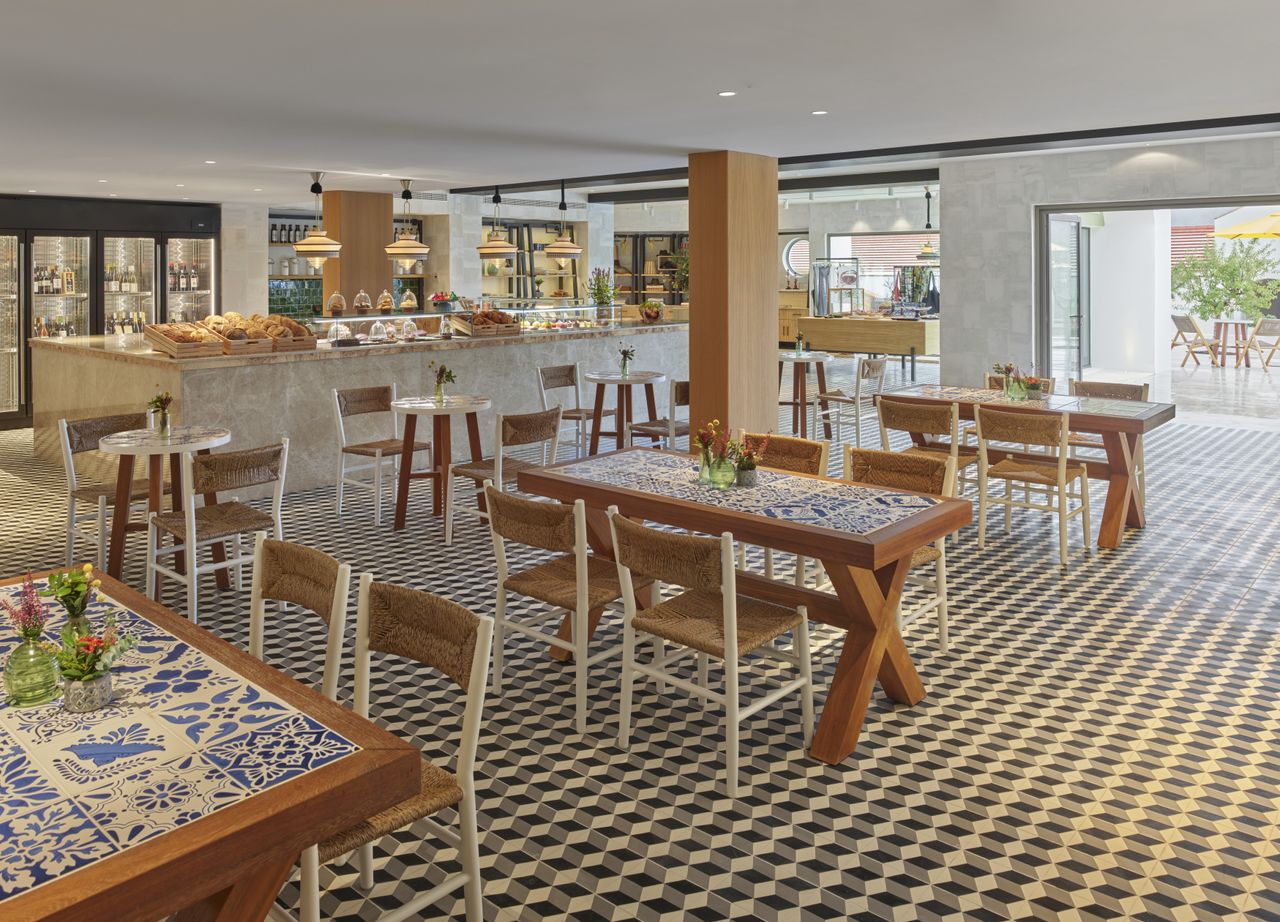 Cafe Central at the Viceroy hotel with lots of dining tables and chairs. The cafe also has a bakery and gelato section.
