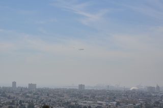 NASA's space shuttle Endeavour soars over Long Beach, Calif., on the way to a Los Angeles landing on Sept. 21, 2012 in this view by shuttle spotter Holly Holbrook. Endeavour landed in Los Angeles to end a 4.5-hour aerial tour of California.