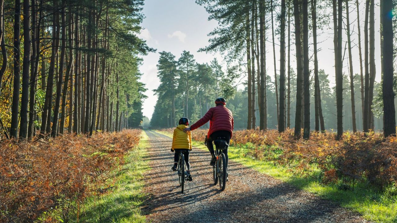 Image of a young and older person riding bikes