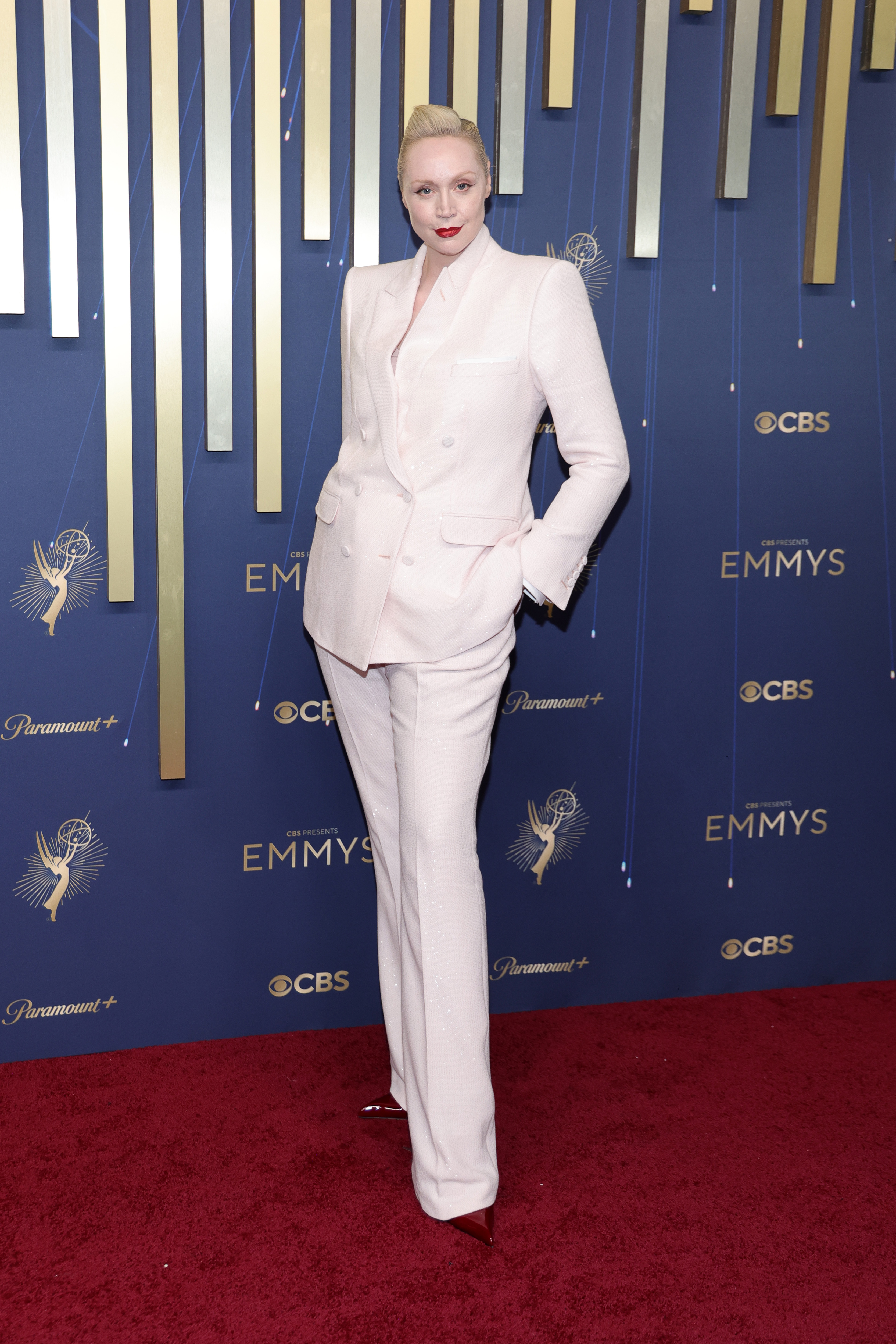 Gwendoline Christie in a white suit on the red carpet