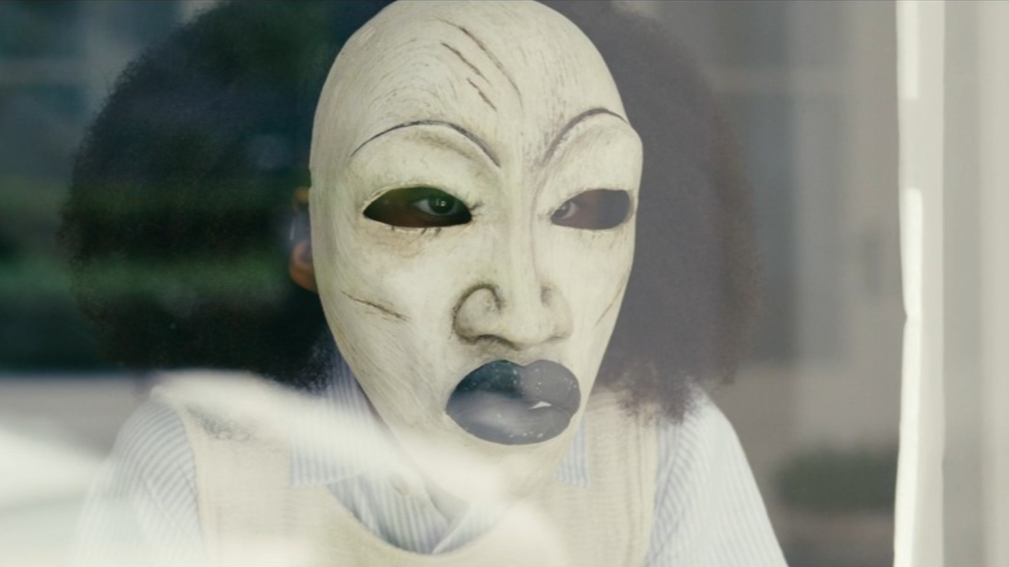 Romy Woods with mask on in Strung.