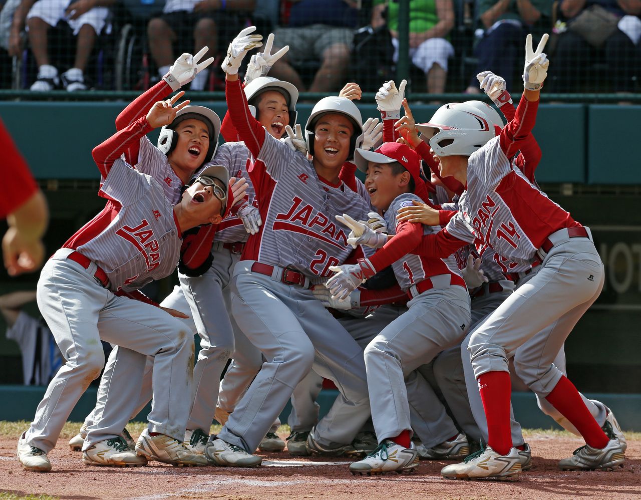 Tokyo&amp;#039;s Little League baseball team celebrates a victory in Williamsport, Pennsylvania.