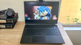 Alienware m18 review unit on desk, sonic the hedgehog 2 playing on screen