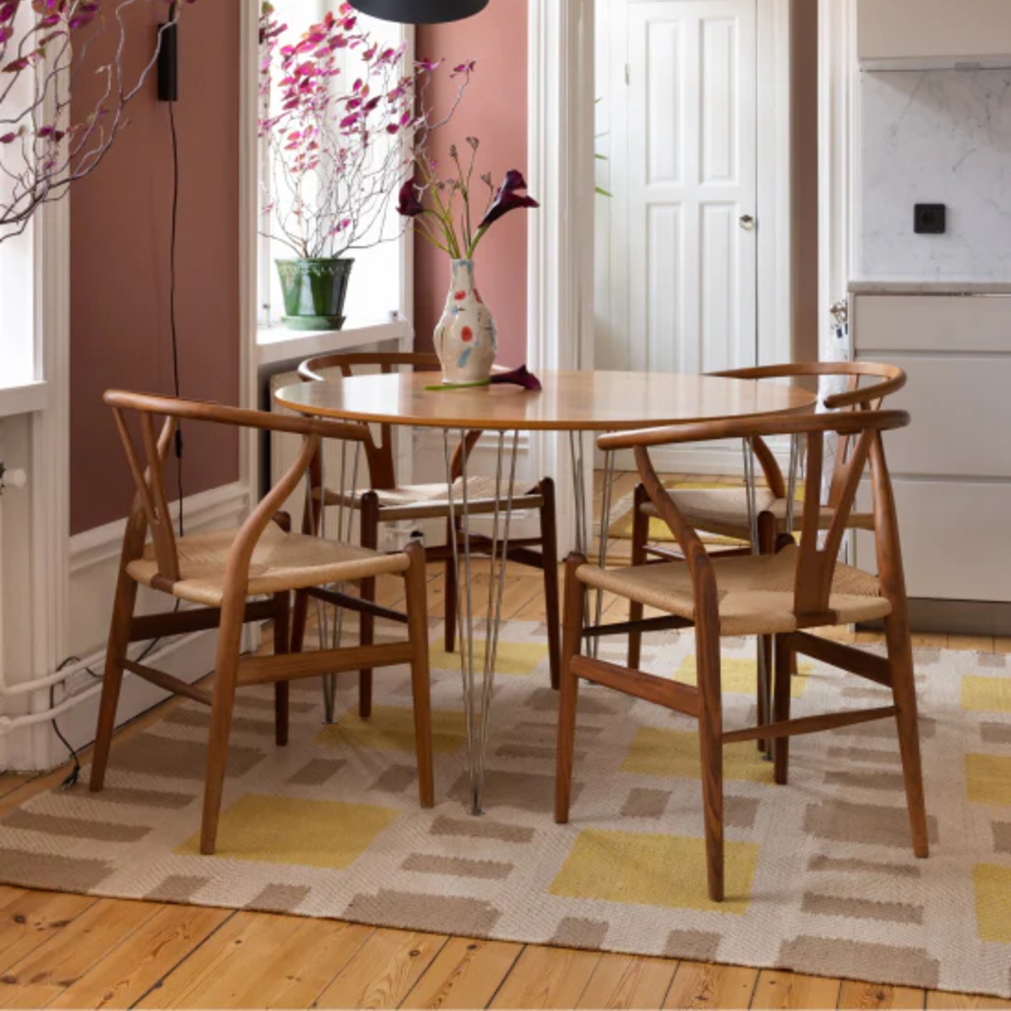 Layered&#039;s Evelina Kroon jute rug in a dining kitchen area with a round dining table
