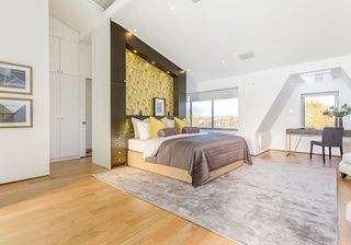 bedroom with white wall and wooden flooring