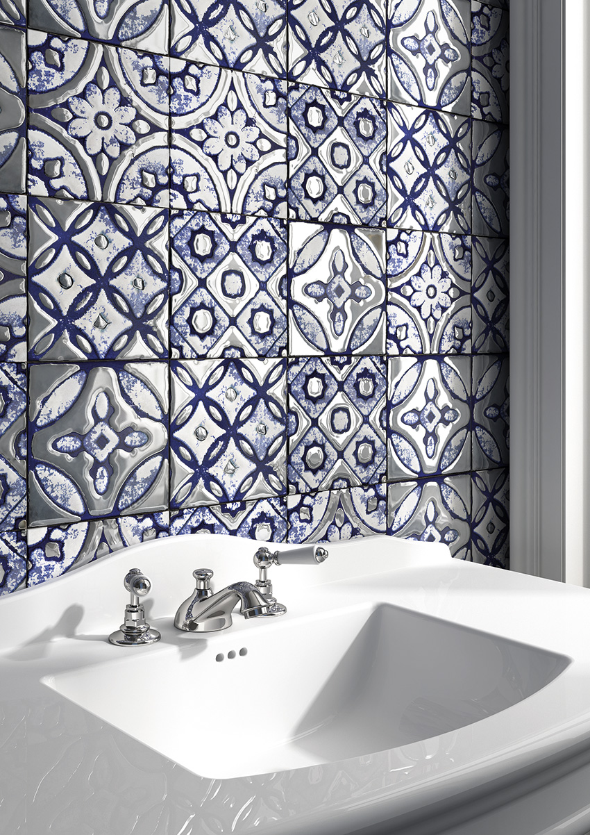 Moroccan-style blue and silver tiles behind a bathroom sink