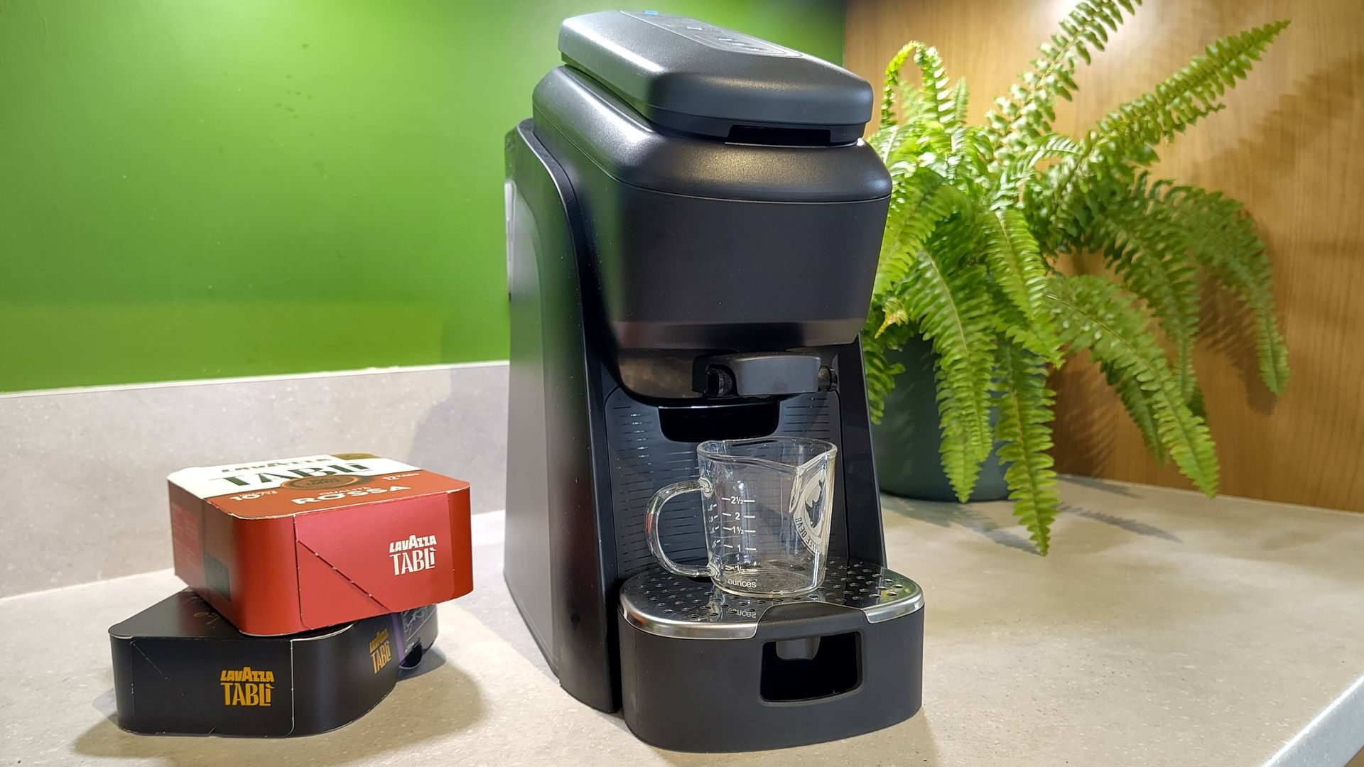 Lavazza Tabli coffee machine on kitchen counter with boxes of coffee tabs