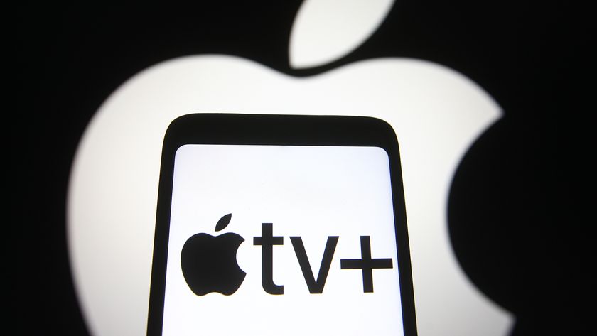 The Apple logo in white glows behind a phone with the Apple TV+ logo on it