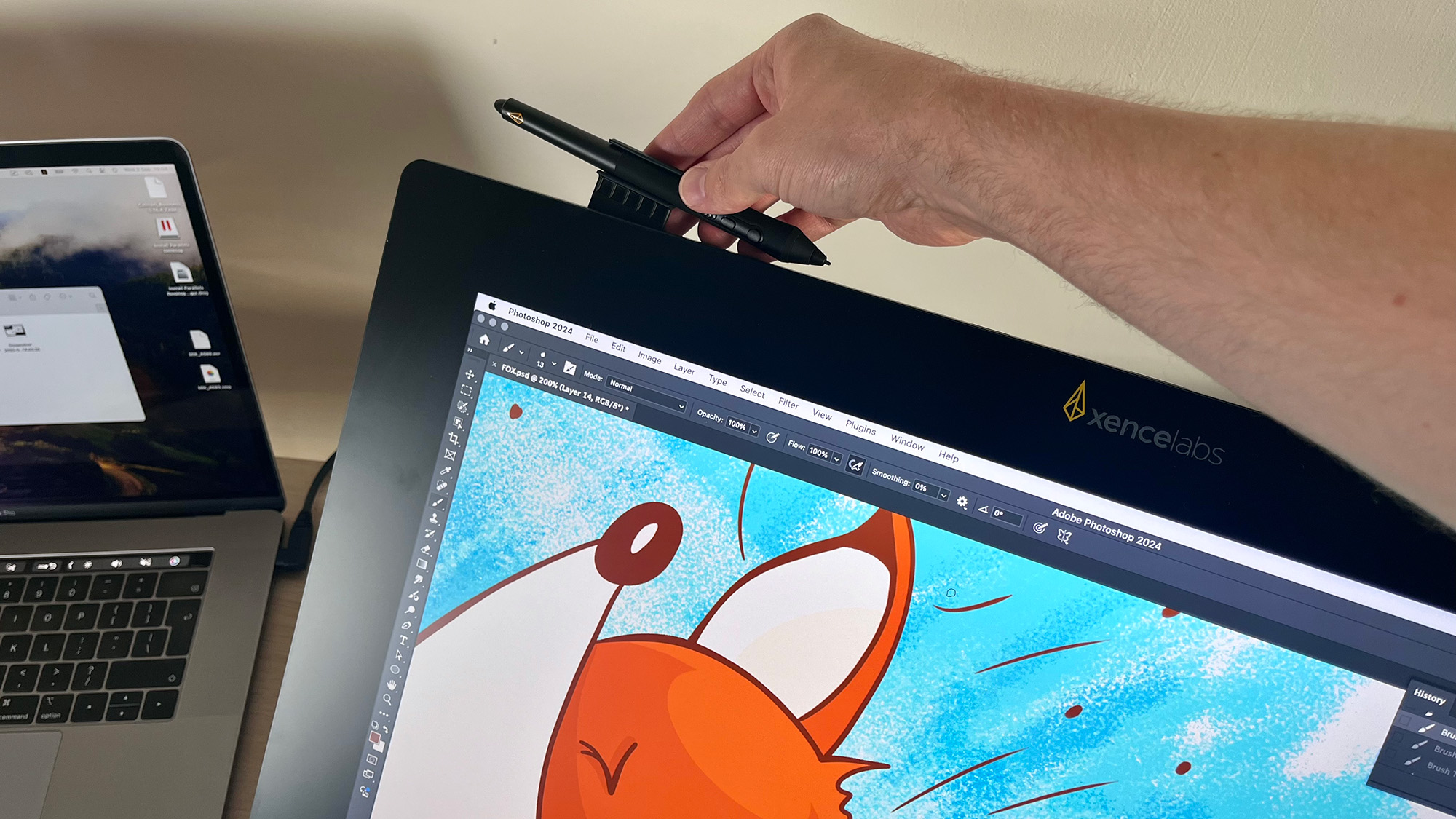 Hand placing Xencelabs stylus in holder on Pen Display 24+ with image of cartoon fox on the screen