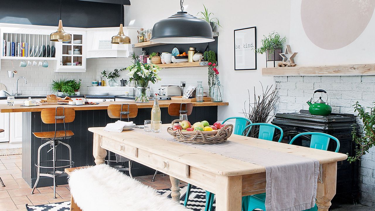 dining area in grey and white kitchen space with wooden table