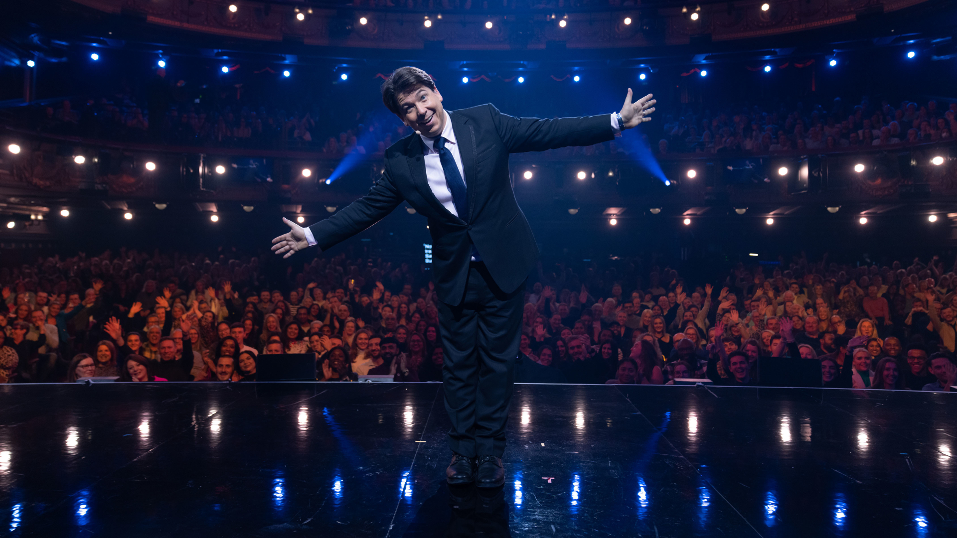 Michael McIntyre poses in front of a live theatre audience