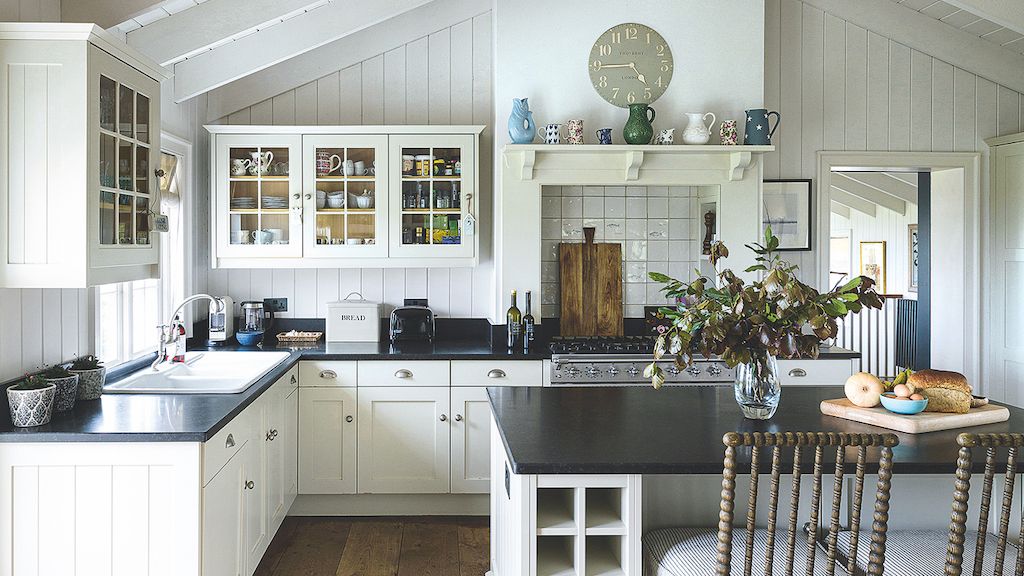 white kitchen with glass cabinet doors and granite tops