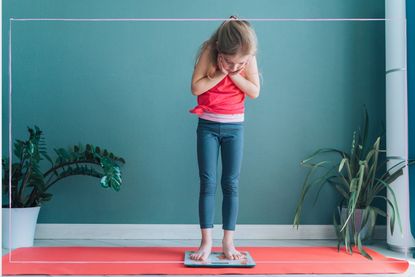 Child standing on a set of scales 